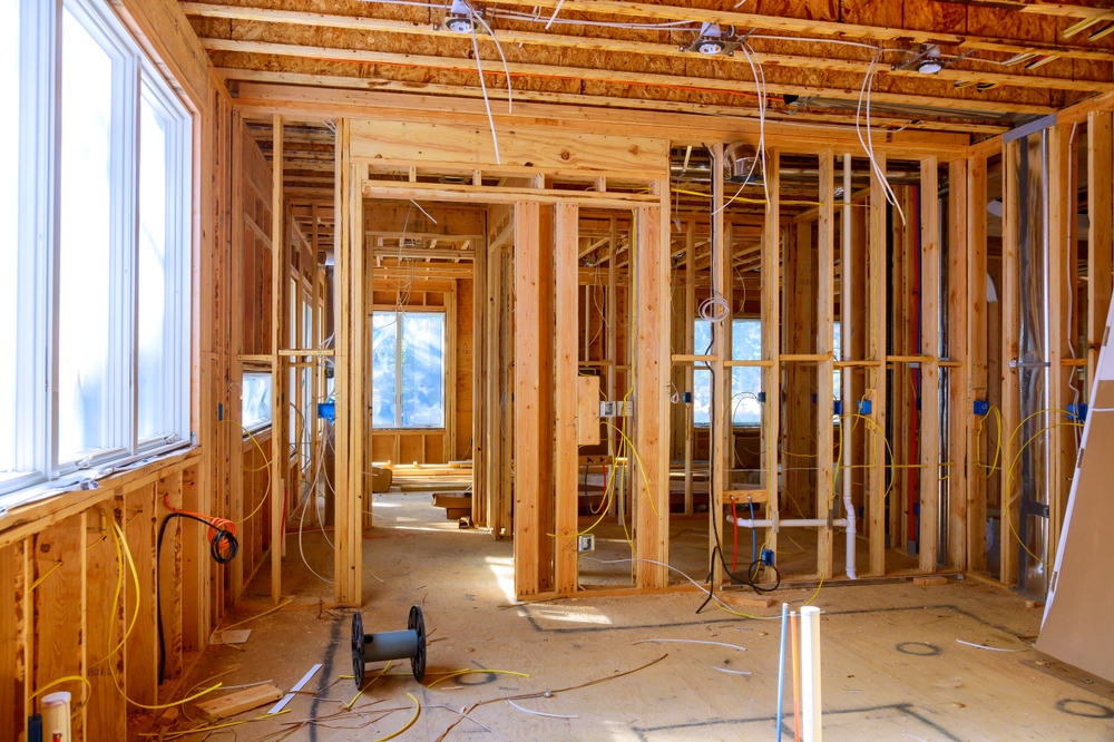 Worker,Installs,Electrical,Wires,,Insulation,,And,Ceiling,Light,Before,Plasterboard